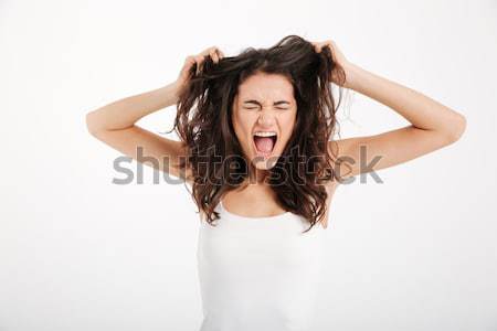 Portrait of a desperate woman suffering from a strong migraine Stock photo © deandrobot