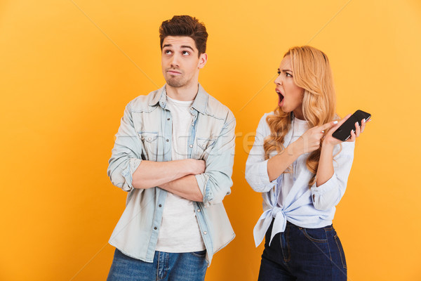 Photo of furious mad woman holding black smartphone and screamin Stock photo © deandrobot