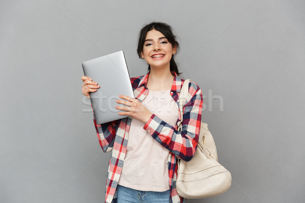 Amazing emotional young lady showing laptop computer. Stock photo © deandrobot