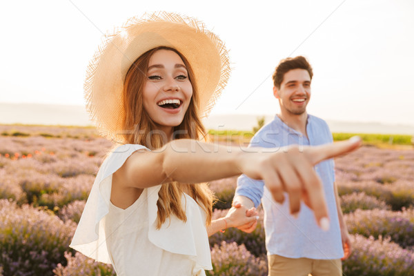 Smiling young couple embracing at the lavender field Stock photo © deandrobot