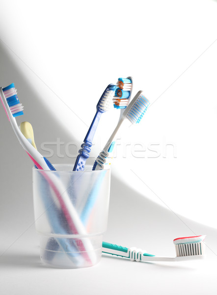Stock photo: Toothbrushes in a glass