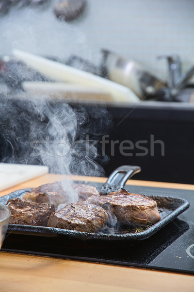 Stock photo: Meat slices roasted on skillet 