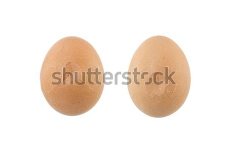 Cracked eggs on white background Stock photo © dekzer007