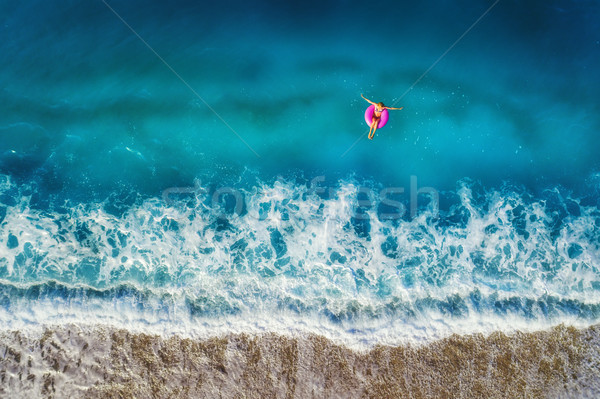 Widok z lotu ptaka kobieta pływanie morza młoda kobieta różowy Zdjęcia stock © denbelitsky