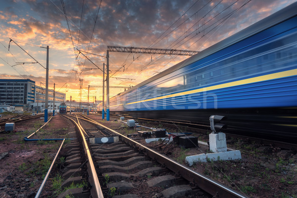Stock photo: High speed passenger train in motion on railroad track at sunset