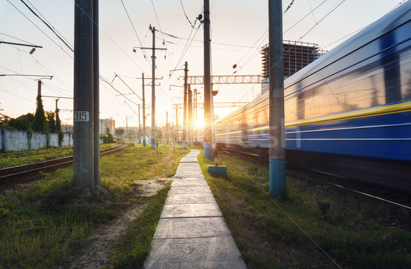 High speed passenger train in motion on railroad track at sunset Stock photo © denbelitsky