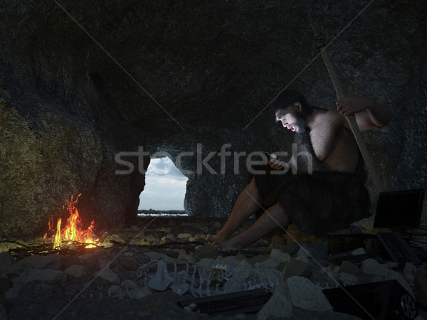 primitive man siting in the cave with smartphone concept illustration Stock photo © denisgo