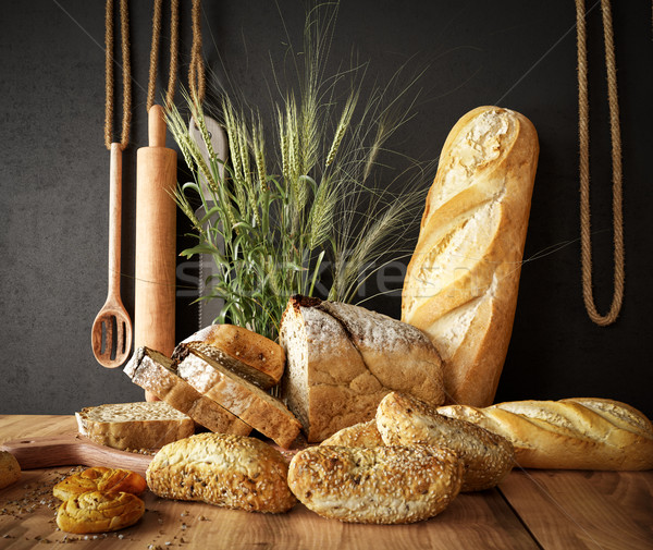 Fresh bread with wheat on a slate cutting board and photo background copy space Stock photo © denisgo