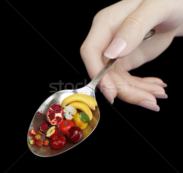 woman hand holding spoon with fruits on isolate black diet concept photo closeup Stock photo © denisgo