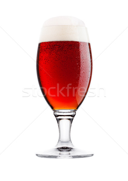 Cold glass of red bitter beer with foam and dew Stock photo © DenisMArt