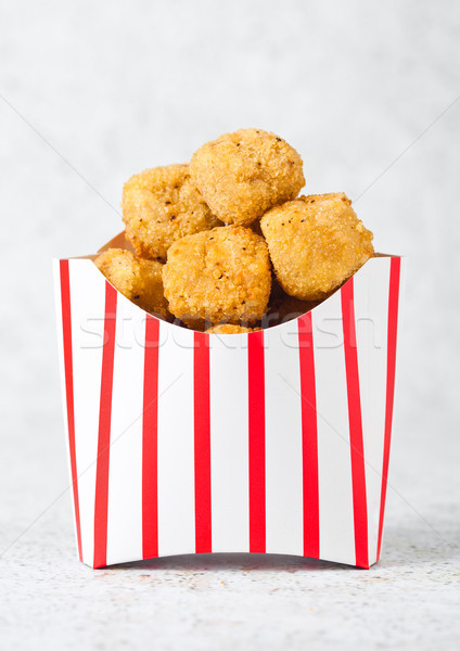 Paper container with fried crispy chicken popcorn Stock photo © DenisMArt