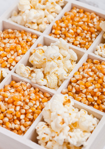 Raw golden sweet corn seeds and popcorn in box Stock photo © DenisMArt