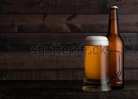 Glass and bottle of golden lager beer with foam  Stock photo © DenisMArt