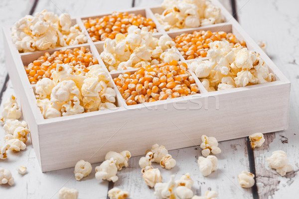 Raw golden sweet corn seeds and popcorn in box Stock photo © DenisMArt