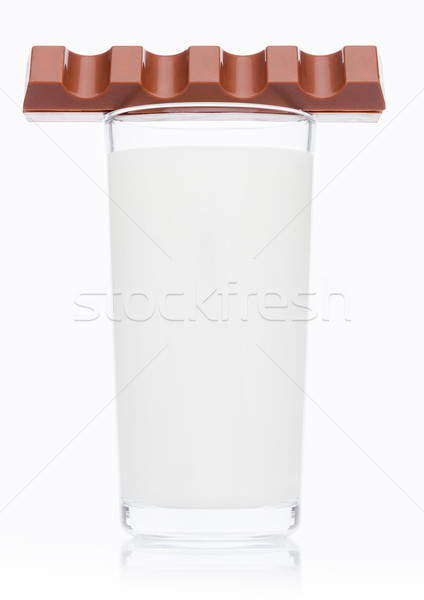 Glass of fresh breakfast milk with chocolate bar Stock photo © DenisMArt