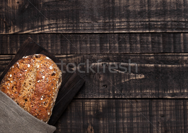 Freshly baked  bread with oats on wooden board Stock photo © DenisMArt