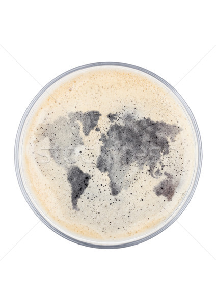 Glass of stout beer top with earth shape Stock photo © DenisMArt