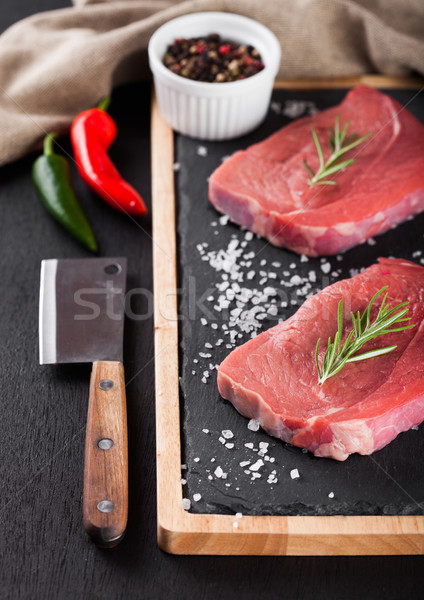 Fresh raw beef steak meat on board with hatchet Stock photo © DenisMArt