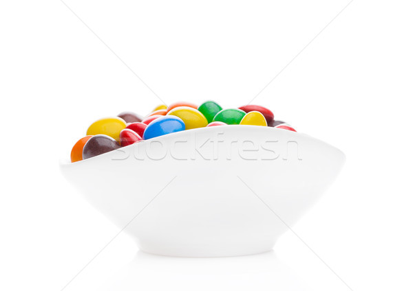 Round colorful coated sweet candies in white bowl Stock photo © DenisMArt