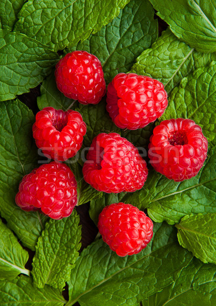 Raspberries on mint leaves clos up photography Stock photo © DenisMArt
