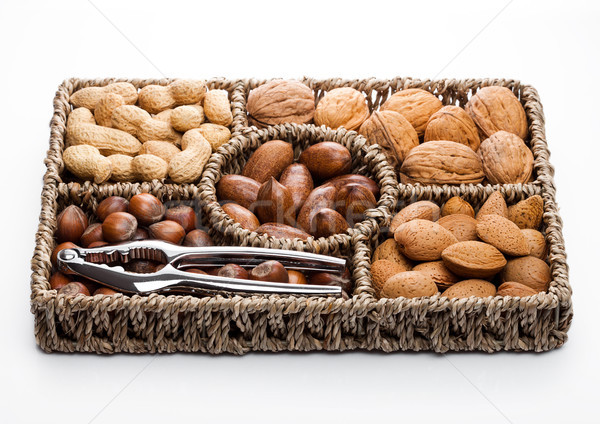 Basket reach in various kinds of nuts in shells Stock photo © DenisMArt