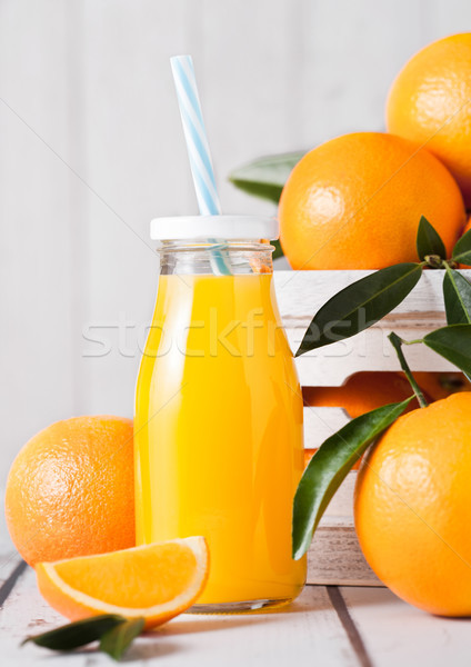 Glass bottle of raw organic fresh orange juice  Stock photo © DenisMArt