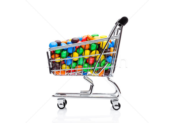 Round coated sweet candies in shopping cart Stock photo © DenisMArt