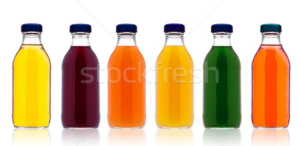 Glass bottles with fresh organic juice on white Stock photo © DenisMArt