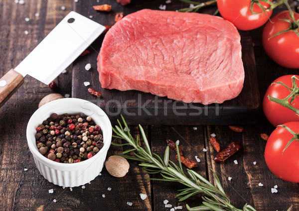 Fresh raw beef steak meat on board with hatchet Stock photo © DenisMArt