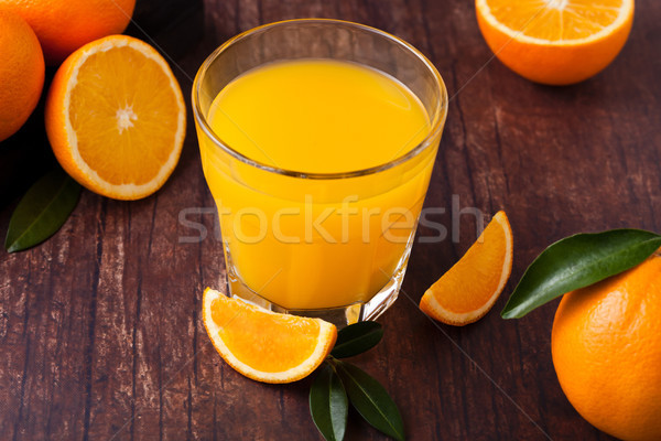 Glass of organic fresh orange juice with fruits Stock photo © DenisMArt
