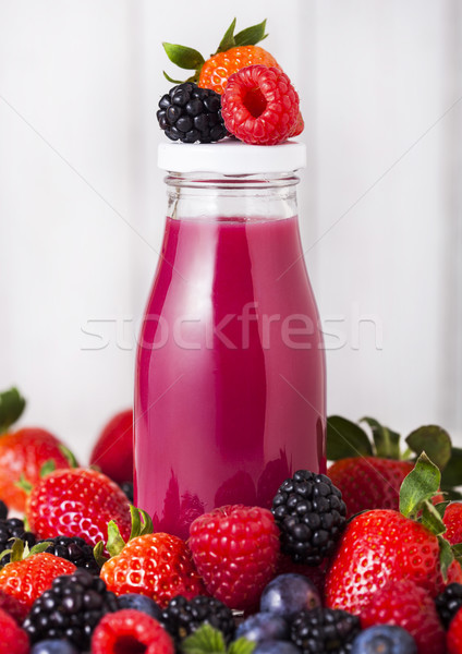 Stock photo: Glass bottles with fresh summer berries smoothie