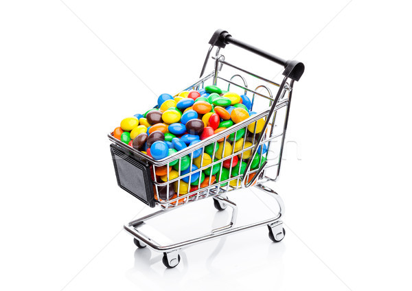 Round coated sweet candies in shopping cart Stock photo © DenisMArt