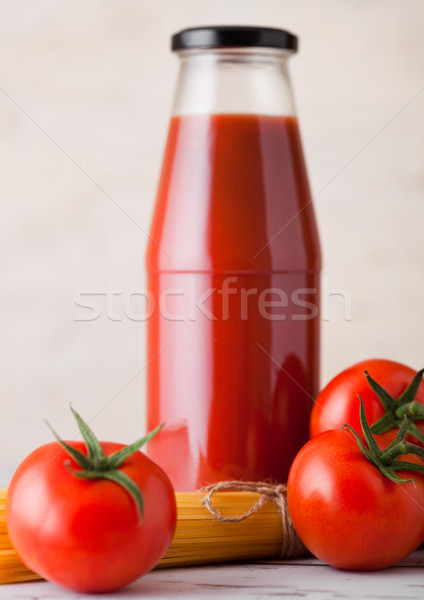 Glass bottle of tomato paste with raw spaghetti  Stock photo © DenisMArt