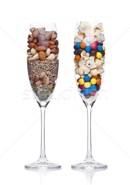 Popcorn and candies glass with healthy nuts glass Stock photo © DenisMArt