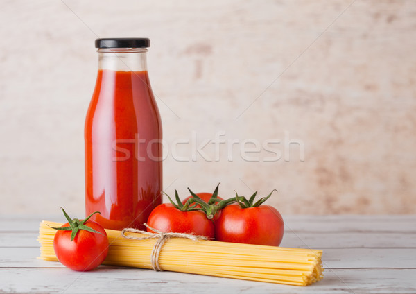 Glass bottle of tomato paste with raw spaghetti  Stock photo © DenisMArt