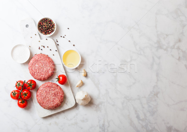 Raw minced home made grill beef burgers with spices and herbs. Top view with space for your text on  Stock photo © DenisMArt