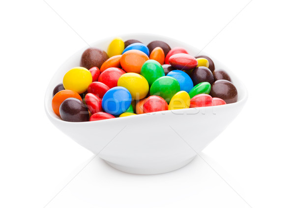 Round colorful coated sweet candies in white bowl Stock photo © DenisMArt