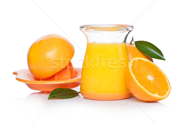 Fresh raw peeled oranges with juice squeezer jar Stock photo © DenisMArt