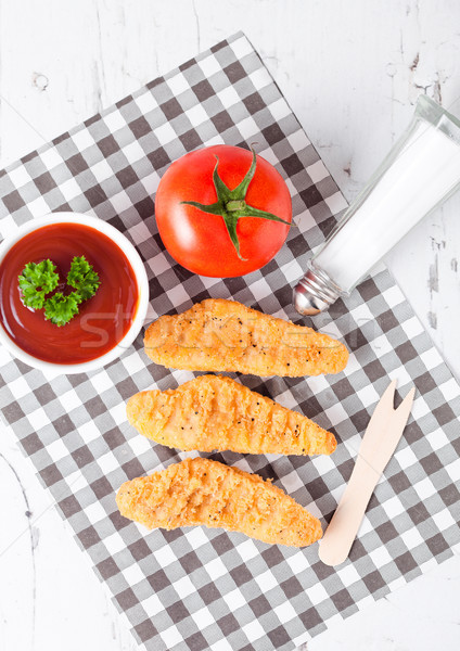 Fried chicken dippers on chopping board with sauce Stock photo © DenisMArt