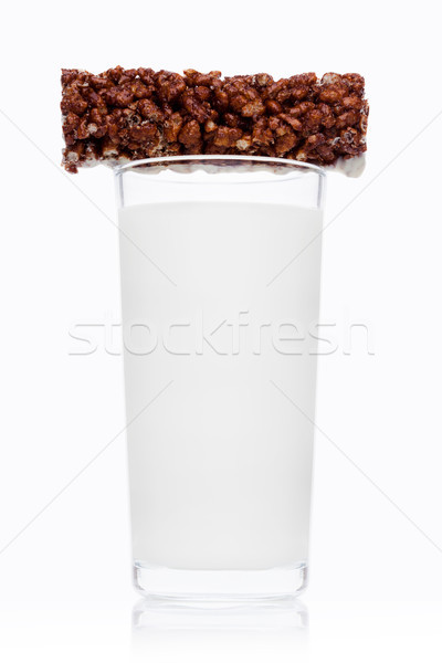 Glass of fresh breakfast milk with choc cereal bar Stock photo © DenisMArt