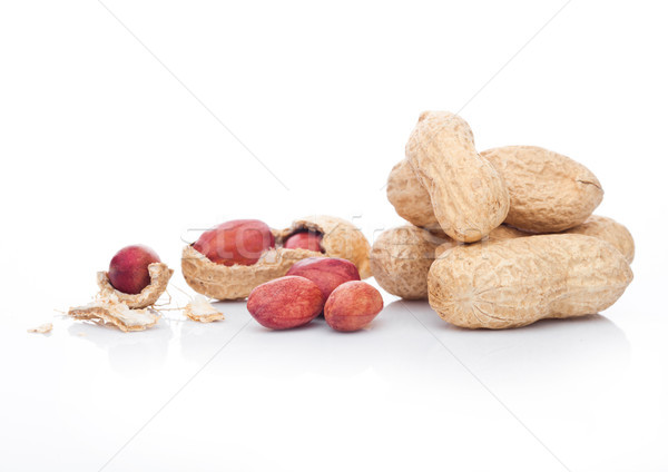 Raw peanuts with shell on white background Stock photo © DenisMArt