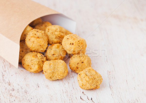 Paper container with fried crispy chicken popcorn Stock photo © DenisMArt