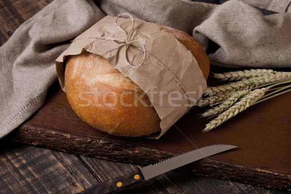 Freshly baked  bread with  kitchen towel and knife Stock photo © DenisMArt