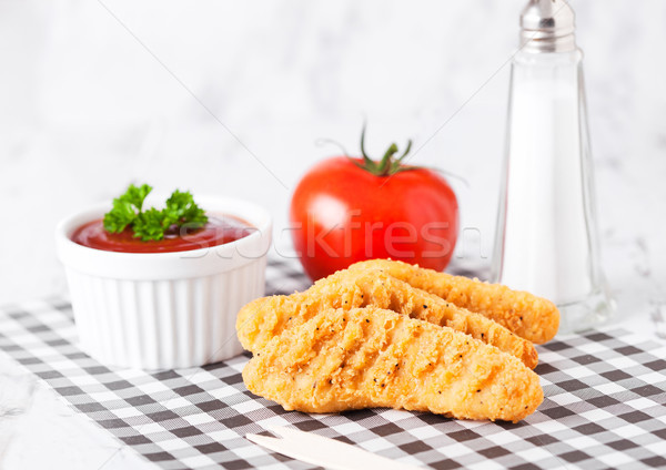 Fried chicken dippers on chopping board with sauce Stock photo © DenisMArt