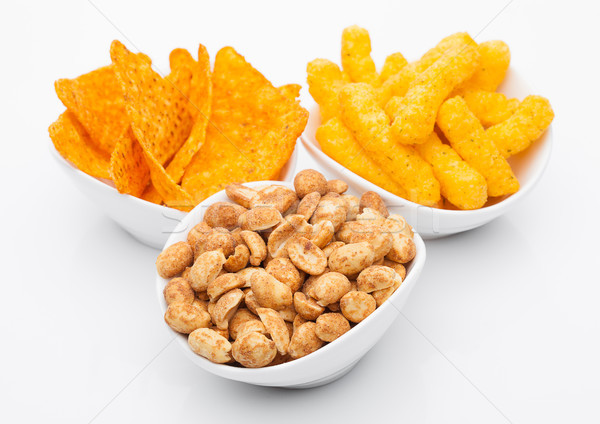 Cheese corn snacks and nachos with salty peanuts Stock photo © DenisMArt