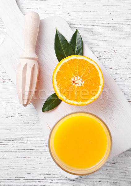 Fresh raw peeled oranges with hand juice squeezer  Stock photo © DenisMArt