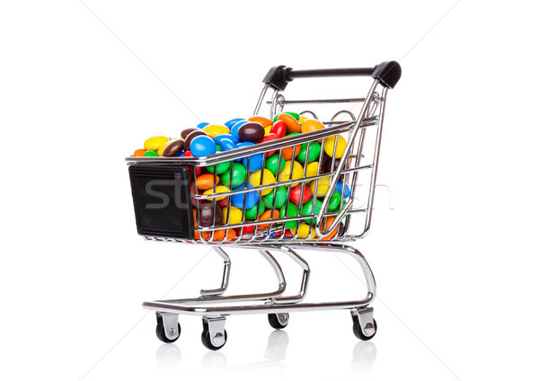 Round coated sweet candies in shopping cart Stock photo © DenisMArt