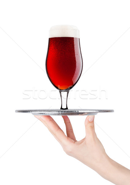 Stock photo: Hand holds tray with cold red ale beer with foam