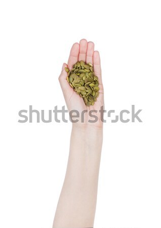 Female hand hold healthy bio pumpkin seeds Stock photo © DenisMArt