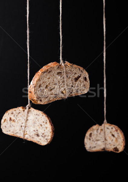 Freshly baked bread with oats hanging on rope Stock photo © DenisMArt